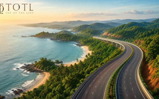 Aerial view of a modern highway passing through the lush green landscapes and coastal region of Sindhudurg, Maharashtra, representing the proposed Shaktipeeth Highway Sindhudurg and its role in improving connectivity, tourism, and long-term real estate investment opportunities.