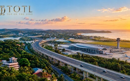 A realistic aerial view of North Goa showing an elevated highway, modern airport terminal, aircraft, lush greenery, coastal landscape and surrounding development, representing connectivity and infrastructure shaping North Goa real estate investment.